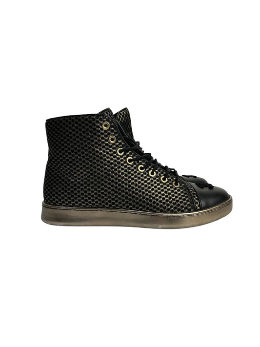 Black high-top sneakers with glossy finish and gold mesh detailing