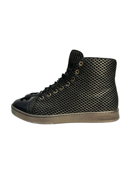 Black high-top sneakers with glossy finish and gold mesh detailing
