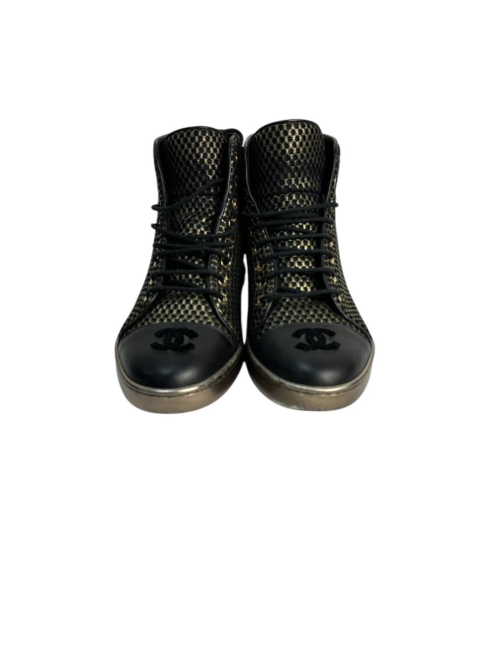 Black high-top sneakers with glossy finish and gold mesh detailing