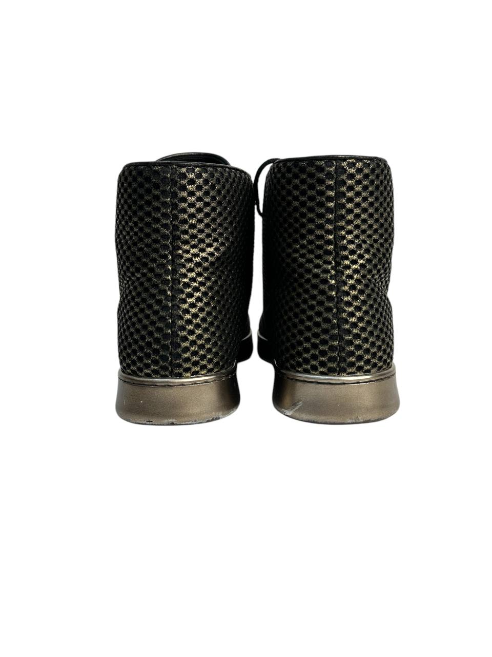 Black high-top sneakers with glossy finish and gold mesh detailing