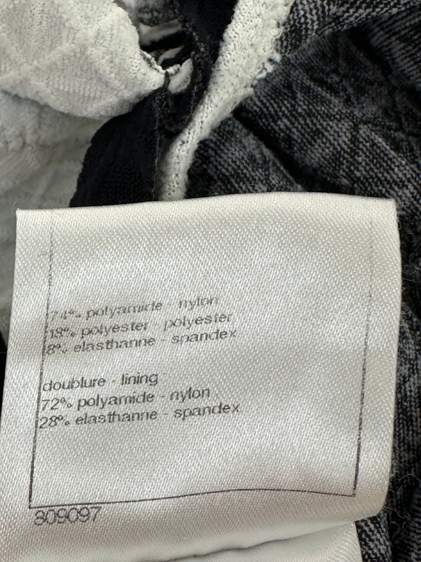 White swimsuit with neckline embellishment